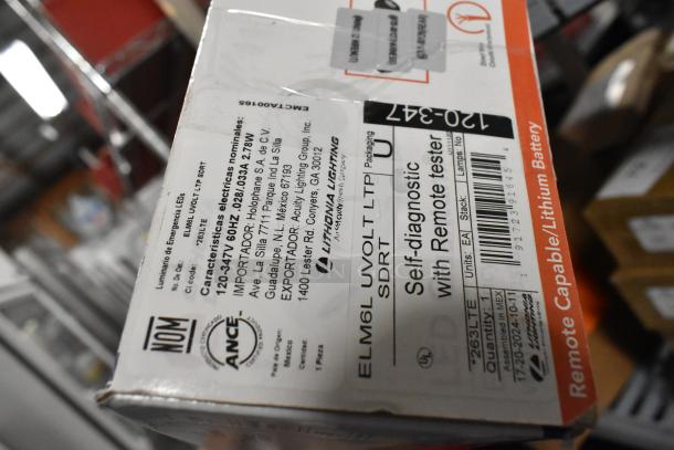 Box of Lithonia Lighting emergency lights with self-diagnostic feature. Includes visible label details and barcode.