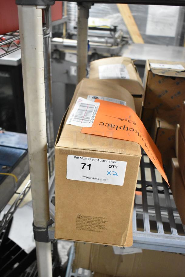 Box containing Dual Lite emergency light, part of two-item auction lot. Label reads "71 QTY x2" for auction identification.