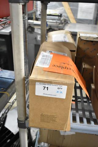 Box containing Dual Lite emergency light, part of two-item auction lot. Label reads "71 QTY x2" for auction identification.