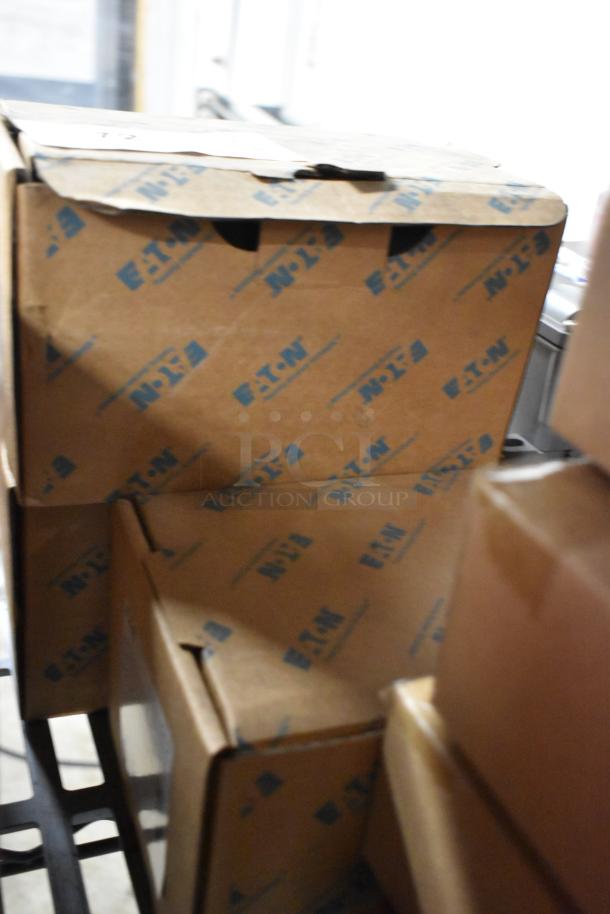 Boxes labeled "Eaton" containing various items, including an AHDS30 Disconnect Switch, shown in packaging.