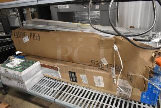 Two boxes of various fluorescent lights on a metal shelf; boxes are partially opened, revealing packaging labels and product numbers.