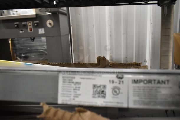 Two boxes containing various fluorescent lights with visible labels and markings, offering double your bid value.