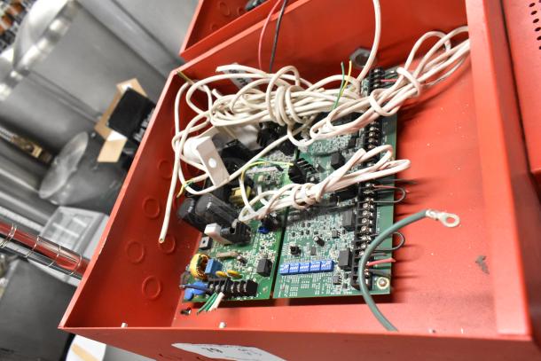 Three Wheelock PS-8 Powerpath NAC Extenders in red enclosures, showing internal wiring and circuitry. Auction item in good condition.