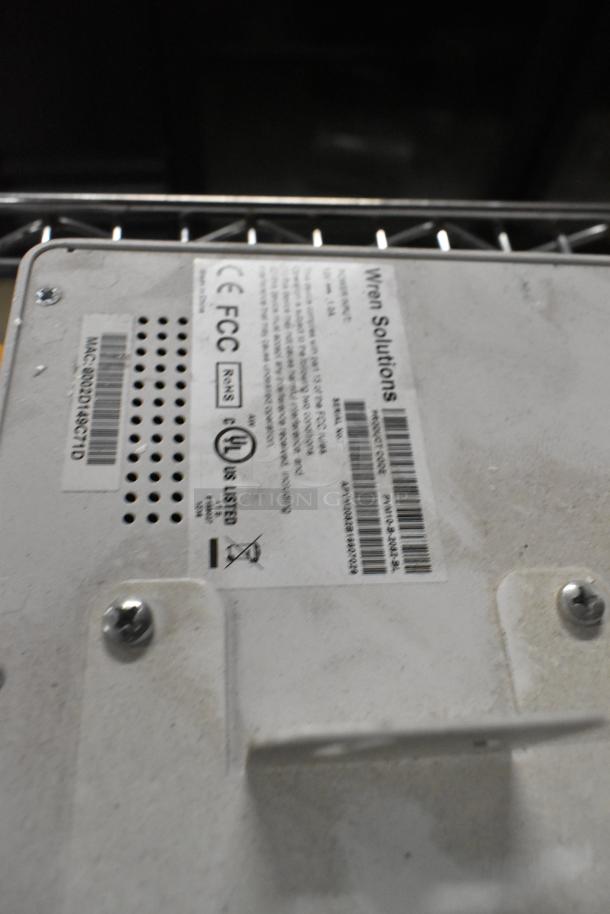 Wren Solutions panel with visible FCC label and certification marks, featuring screws and vent holes, in good condition.