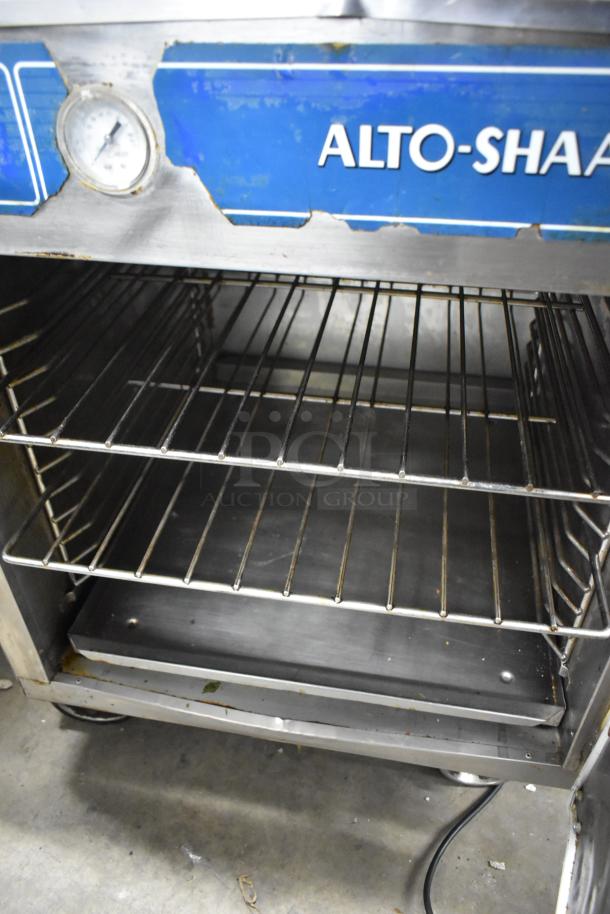 Alto Shaam 750-S stainless steel heated holding cabinet, visible shelves, temperature gauge, on commercial casters.