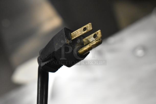 Close-up of a 3-prong electrical plug, part of the Alto Shaam 750-S commercial heated holding cabinet.