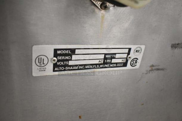 Alto Shaam 750-S stainless steel commercial heated holding cabinet label showing model, voltage, and serial number details.