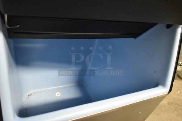 Ice-O-Matic ICE1006HW7 commercial ice machine head on bin, stainless steel, 208-230V, 1 Phase, clean interior, used condition.