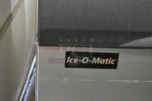 Ice-O-Matic ICE1006HW7 stainless steel commercial ice machine head on bin, includes brand label, 208-230V, 1 Phase.