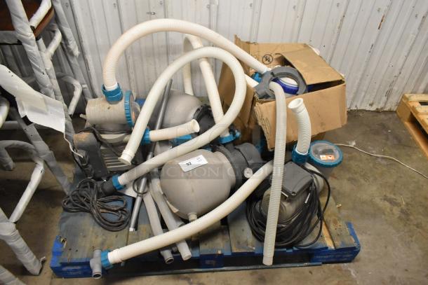 Bestway 58498E Sand Filter System on a pallet, features multiple hoses and components, condition appears used. Tags indicate model and specifications.