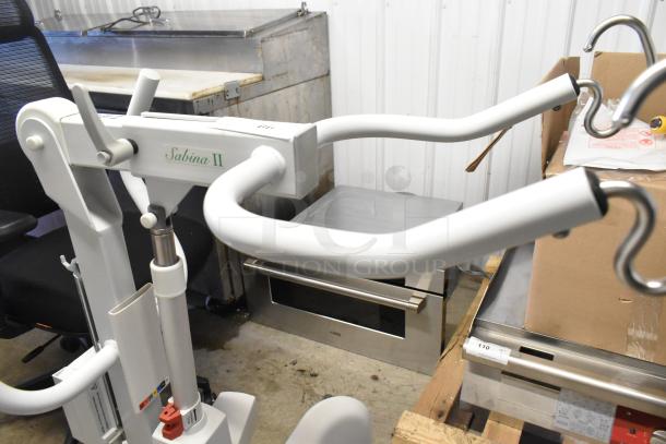 Sabina II Sit To Stand Patient Lift, white, ergonomic handles, condition: good, model label visible.