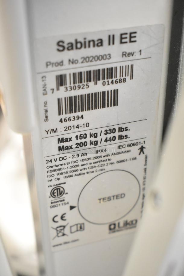 Alt text: Sabina II Sit To Stand Patient Lift label showing model details, max capacity of 200 kg, and compliance markings.