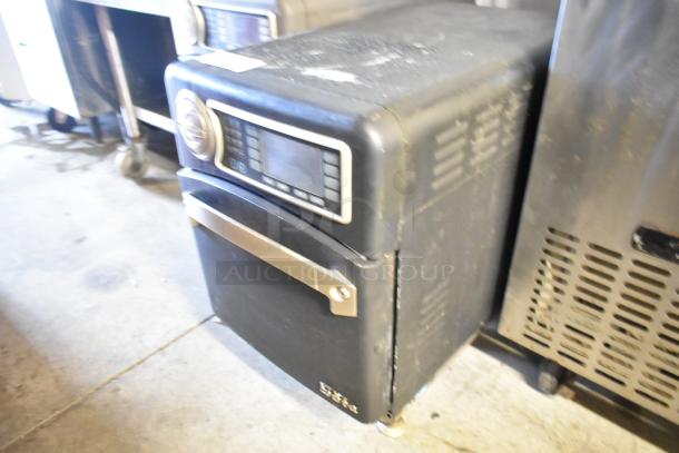 Turbochef NGO rapid cook oven, black metal, countertop model, electric 208/240V, 1 Phase, visible wear, intact control panel.