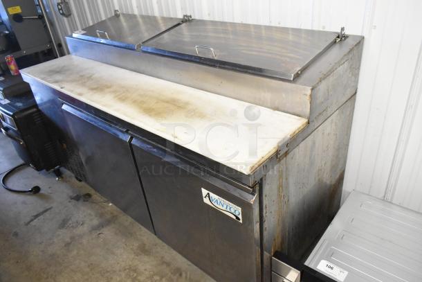 Avantco 178PICL2 stainless steel pizza prep table with commercial casters, visible wear, 115V, 1 phase.