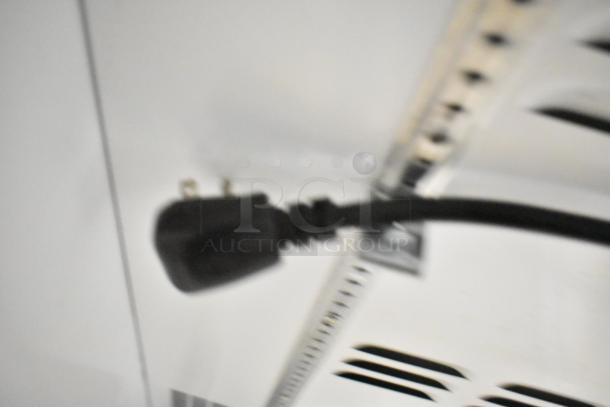 Blurred image showing a power cord inside a Habco SE18 cooler. Features metal body, poly-coated racks, 115V, 1-phase.
