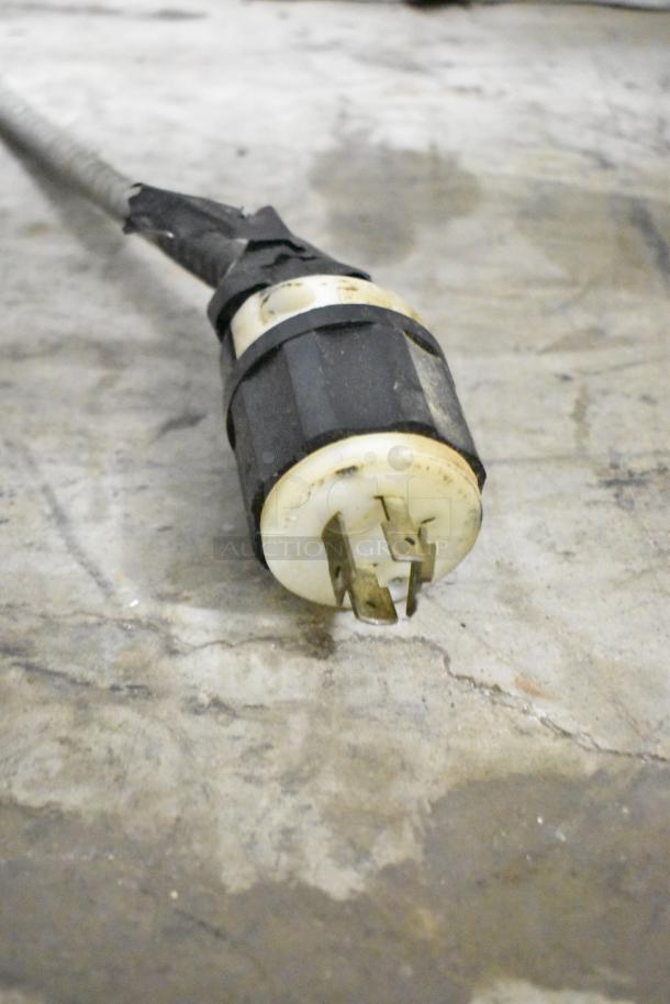 Power plug of a Varimixer W60P 60 Quart Planetary Dough Mixer, 208V, 3 Phase, shown on a concrete surface.