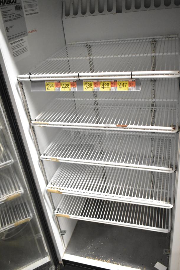 Habco SE12 single door reach-in cooler, metal, poly-coated racks, 115V, 1 phase, visible wear and pricing labels inside.