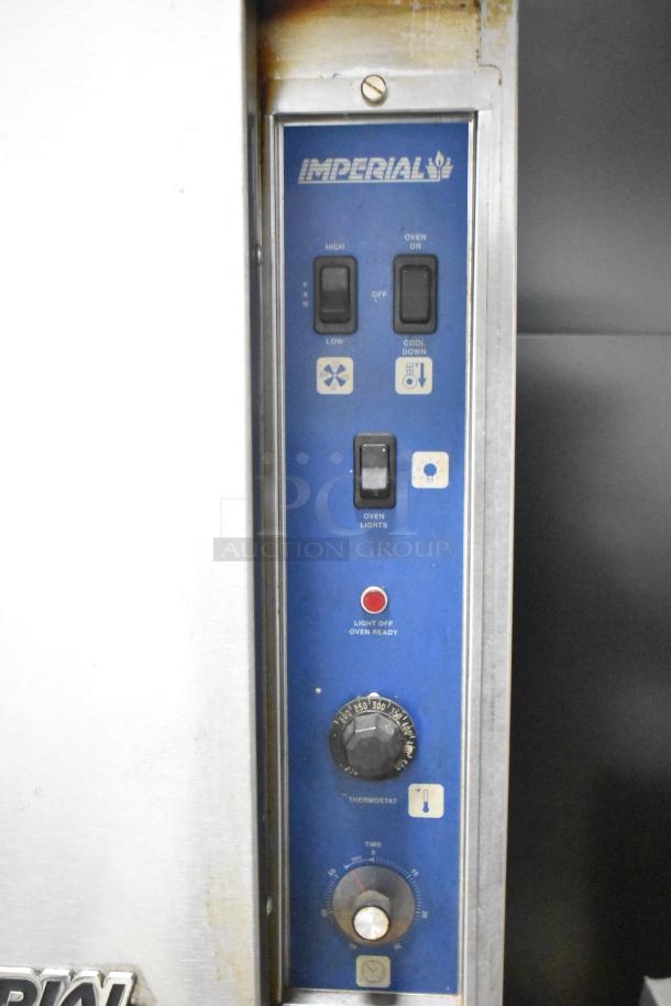 Imperial stainless steel convection oven, solid door, view-through panel, metal racks, thermostatic controls visible.