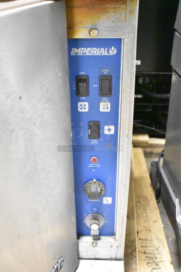 2 Imperial stainless steel commercial full-size convection ovens with view through doors, metal racks, and thermostatic controls.