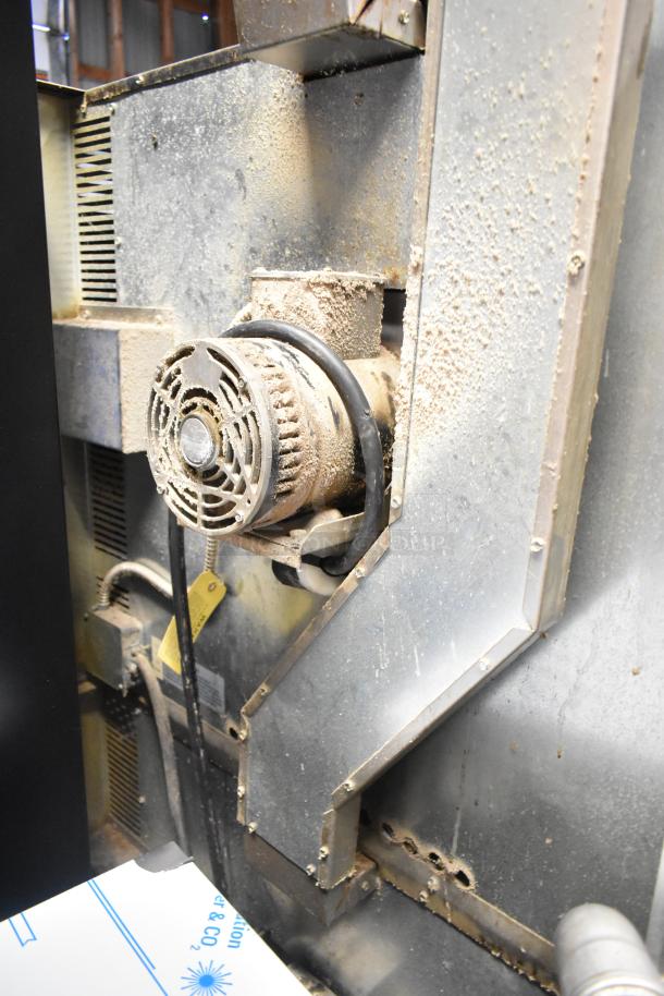 Imperial stainless steel convection oven, dusty exterior, metal racks, thermostatic controls visible. Solid and view-through doors.