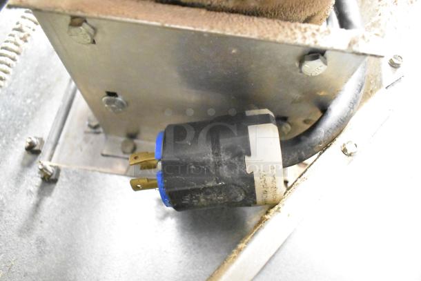 Close-up of electrical plug for Imperial stainless steel convection oven, showing wiring and mounting hardware.