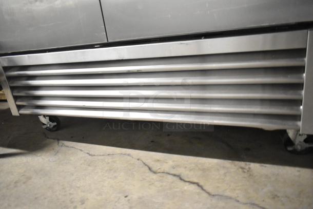 2020 True T-49F-HC stainless steel commercial freezer, 2 doors, with poly-coated racks, on commercial casters, 115V, 1 phase.