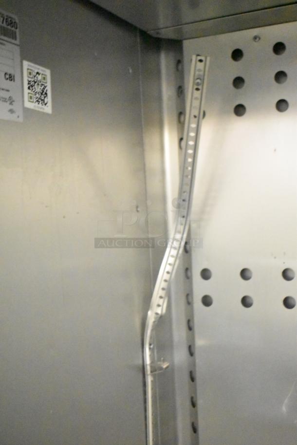 2018 True T-23F-HC stainless steel freezer interior showing poly coated racks and commercial casters, label visible.
