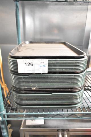 Stack of 36 poly food trays on shelf, slight wear visible. Label indicates lot number 126, quantity 36, from PCIAuctions.