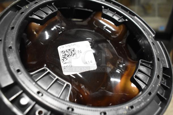 Plastic keg with QR code label indicating potential tracking or identification. Black rim, brown transparent body.