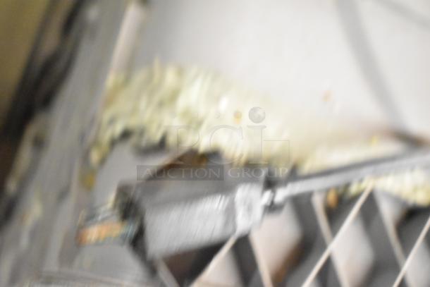 Blurry image, unable to discern specific details of the Samsung DW80M2020US dishwasher.