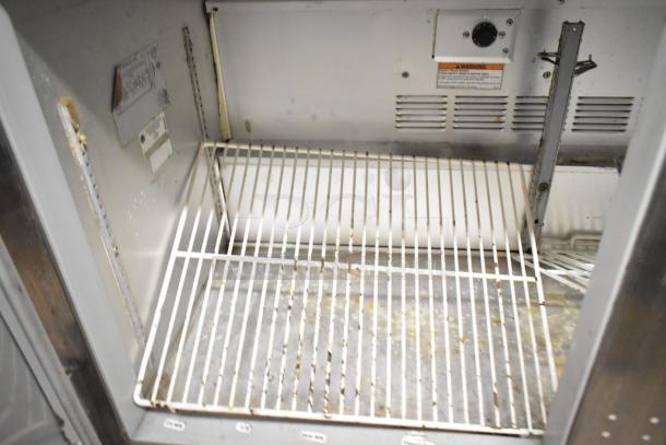 Beverage Air UCR48A stainless steel undercounter cooler interior. Features two doors, wire shelves, 115 volts, 1 phase. Slight wear.