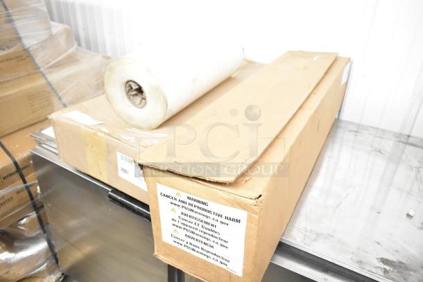 Roll of material and two boxes with Hobart metal pieces, one with a warning label about cancer and reproductive harm.