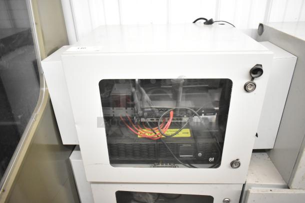 2 BlackShields DC0300 white metal cabinets with glass front, visible internal equipment, in used condition.