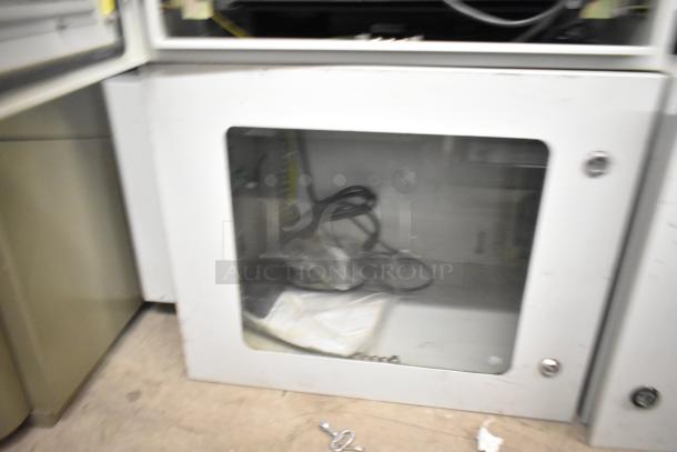 BlackShields DC0300 white metal cabinet with glass front, containing cables. Visible wear. Auction includes two units.