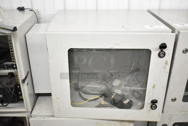 2 BlackShields DC0300 white metal cabinets, visible wear, clear front panel, includes cables. Locking latches present.