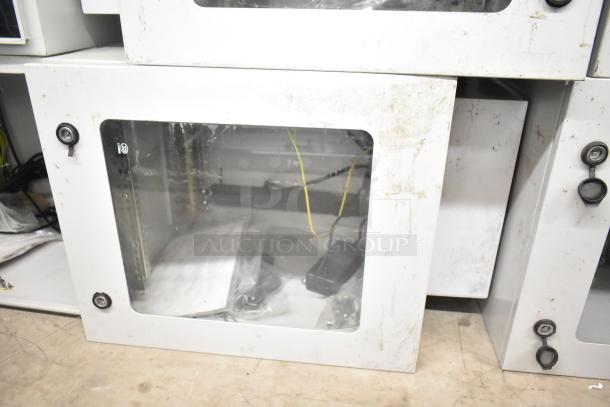 2 BlackShields DC0300 white metal cabinets with transparent doors; visible wear, includes locking mechanisms.