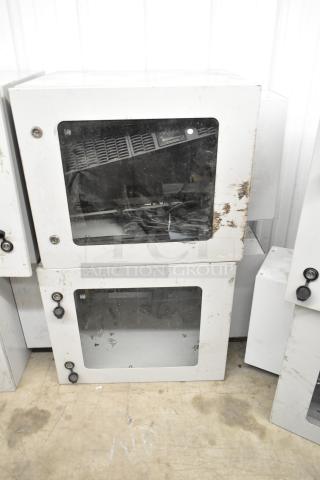 2 BlackShields DC0300 white metal cabinets with glass doors, signs of wear, visible locks, auctioned at 2x bid.
