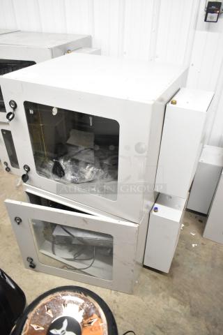 Two BlackShields DC0300 white metal cabinets with glass doors, visible interior equipment, and minor exterior wear.