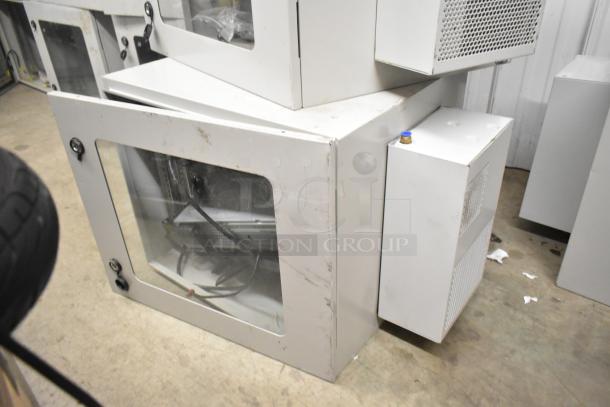 2 BlackShields DC0300 white metal cabinets, slightly worn, with clear front panels and side ventilation units.