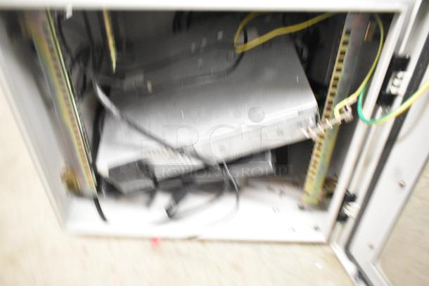 2 BlackShields DC0300 white metal cabinets. Features internal shelving and wiring. Used condition. Model markings visible.