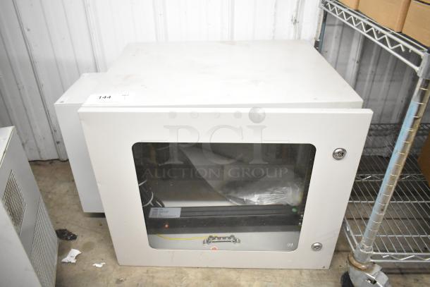 BlackShields DC0300 white metal cabinet, used condition, glass front with visible cabling, model tag on bottom.