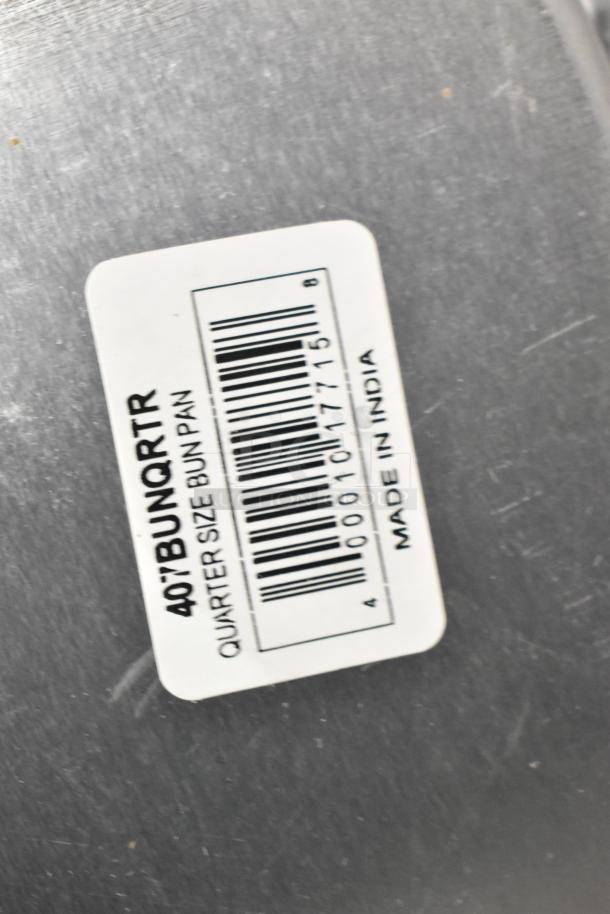 Label on aluminum bun pan reads "407BUNQRTR, Quarter Size Bun Pan, Made in India."