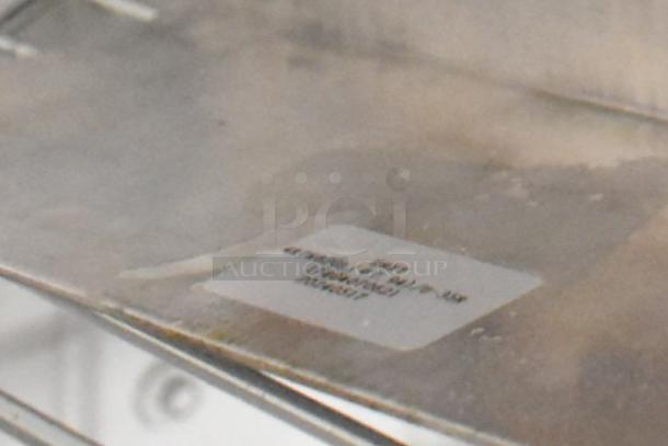 Brand new evaporator coil with slight scratches and dents, visible label indicating model details.