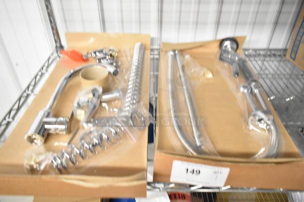 Brand new faucet with spray nozzle attachment, chrome finish, in original packaging. Scratch and dent, model unknown.