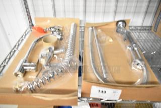 Brand new faucet with spray nozzle attachment, chrome finish, in original packaging. Scratch and dent, model unknown.