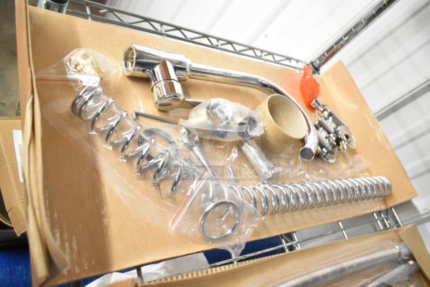 Brand new scratch and dent faucet with spray nozzle attachment, chrome finish, in box, some components sealed in plastic.