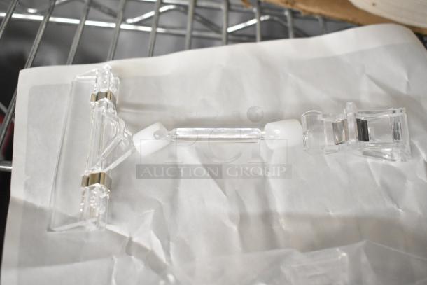Clear plastic poly unit with metal hinges, shown on a white background. Auction includes a set of six units.
