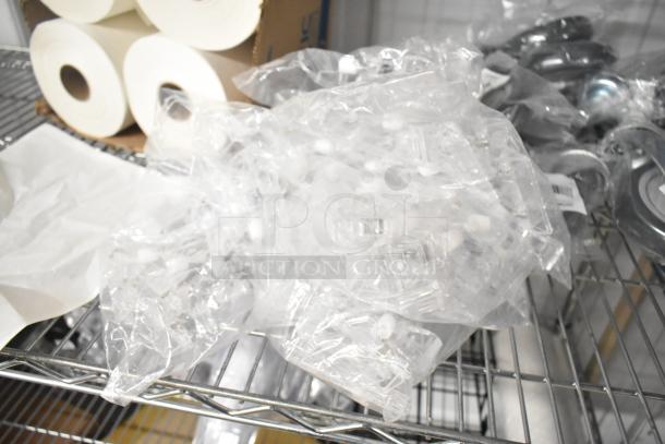 Clear poly units in plastic bags on a metal shelf. Auction for six times your bid.