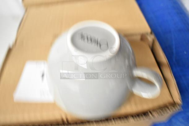 Nine boxes of four ceramic mugs, brand new. Mug underside shows a partial logo. Boxes are sealed and in excellent condition.