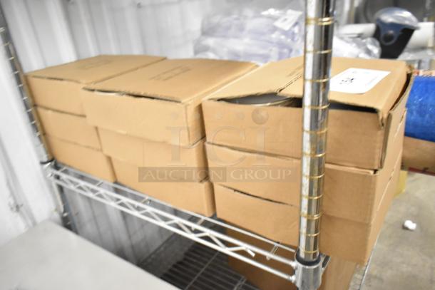 Nine boxes of brand new ceramic mugs, each containing four mugs, stacked on metal shelving. Sealed in cardboard packaging.